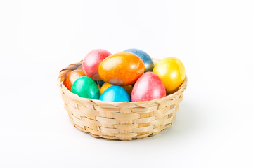 Fototapeta na wymiar Easter eggs in a basket on a white background.