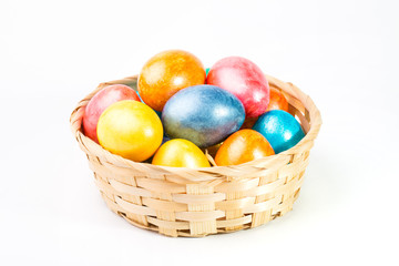 Fototapeta na wymiar Easter eggs in a basket on a white background.