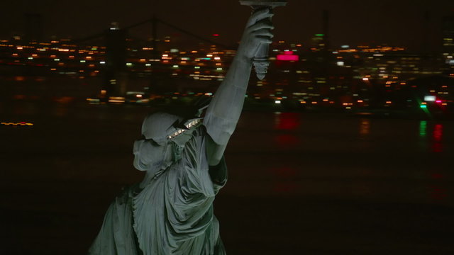 Statue of Liberty at night, closeup aerial shot