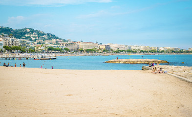 Fototapeta na wymiar People on the most popular beach in Cannes, France - Plage de la Croisette - the famous beach on the Croisette, known for its film festival.