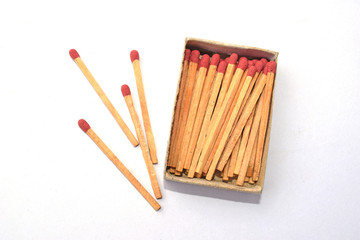 The box of matches and the other 4 matches outside the box  isolate on white background