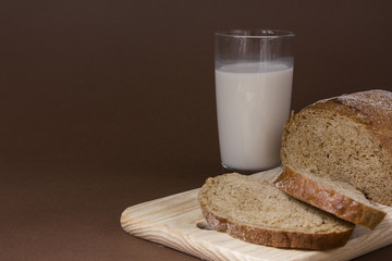 Glass of milk and sliced bread. Background