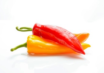 colored peppers over white background