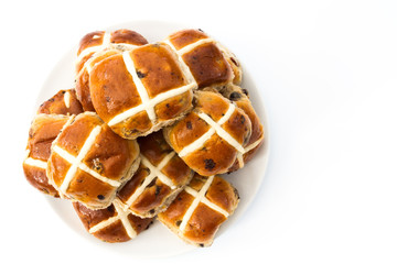 A plate full of Easter, hot cross buns on an isolated white background. View from above looking down.