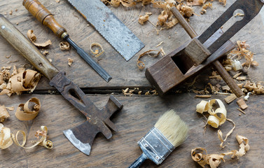 Woodworking tools with wooden background and shavings