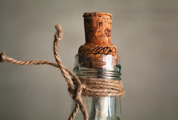 old bottle with cork and note inside. vintage bottle with a message in the time of pirates. modern art handmade