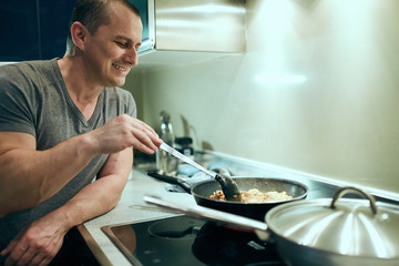 Man cooking at home alone