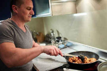 Man cooking at home alone