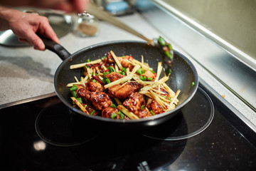 Chicken wings in a wok