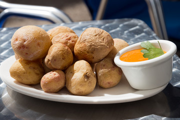 Papas Arrugadas with Mojo, pepper sauce - Traditional canarian dish. Small new potatoes which are cleaned with peel are usually served with a pepper sauce, called Mojo

