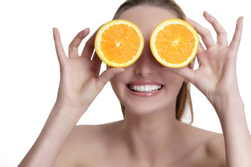 Beautiful happy girl showing a juicy orange