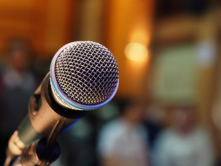 Closeup microphone in meeting room or conference room with blurred light background for business...