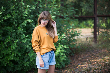 Beautiful hipster girl posing  in the park