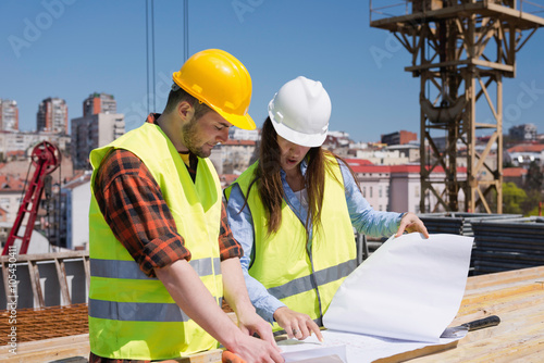 architect and construction worker at construction site, looking at architect and construction worker at construction site, looking at