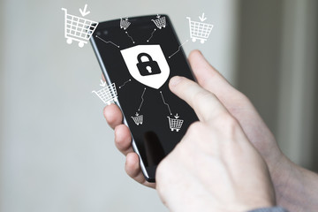 Businessman pressing button security shield virus locked shopping cart phone