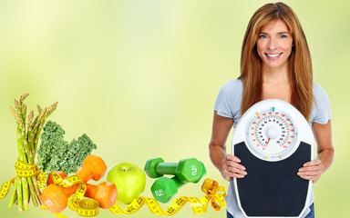 Woman with scales over green background.