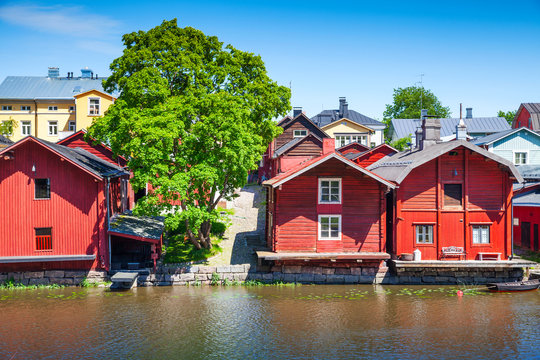 Old red wooden houses on river coast, Porvoo