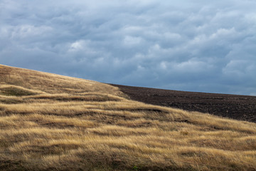 Naklejka premium Colorful farming field in the autumn cloudy weather