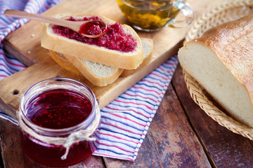 Raspberry jam with bread and tea