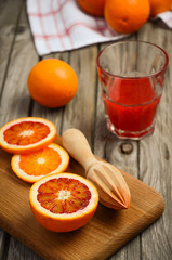 Bloody oranges with juice. Rustic background. Selective focus.