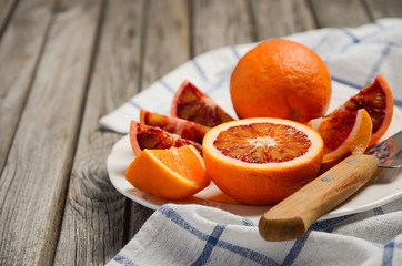 Bloody oranges on the wooden table. Rustic background. Horizontal permission. Selective focus. Copy...