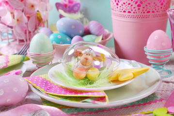 easter table decoration with eggs and flowers in pastel colors