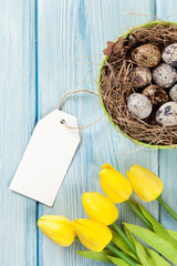 Easter with eggs and yellow tulips