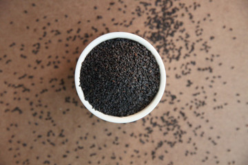 Pile of poppy seeds on wood background