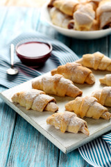 Fresh homemade croissants on a blue wooden table