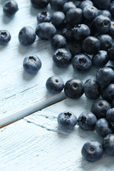 Blueberries on a blue wooden background