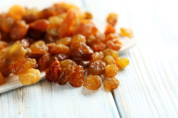Dried raisins on a blue wooden table