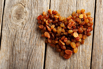 Dried raisins on a grey wooden table