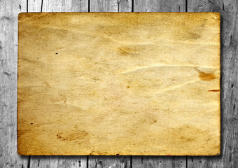 Vintage old grungy paper banner on wood texture background