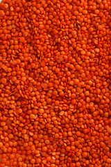 Red lentils background, close up
