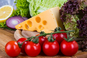 yellow cheese with fresh vegetables