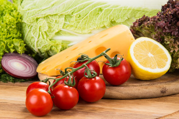 yellow cheese with fresh vegetables