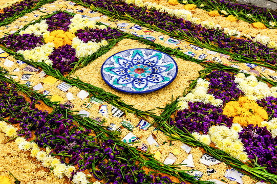 Handmade carpet of sawdust, flowers & ceramic in path of Lent procession in colonial town with most famous Holy Week celebrations in Latin America.