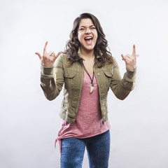 Young woman doing rock horn hand gesture