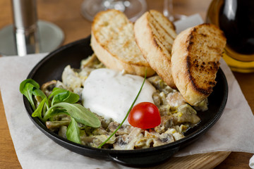 hot pan fried mushrooms with vegetables and croutons