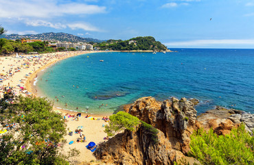 A crowd of vacationers enjoy the warm beaches of Costa Brava in Lloret de Mar.