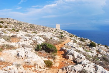 Dry Maltese landscape and a nature trail leading to the watchtower in the area surrounding the Mnajdra Temple in Malta.