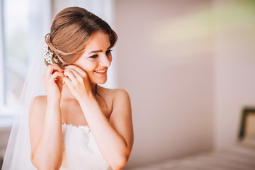beautiful brunette stylish bride getting ready in the morning in the room