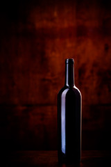 bottle of wine on dark red background