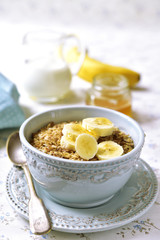 Granola with milk and banana slices.