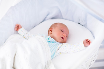 Cute newborn baby in white bed