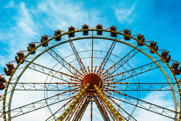 Ferris wheel on the blue sky background