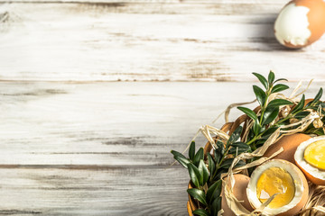 Easter eggs in easter basket on wooden background.