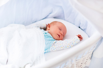 Cute newborn baby in white bed