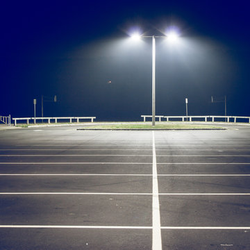 Parking lot with street light at night, filtered image