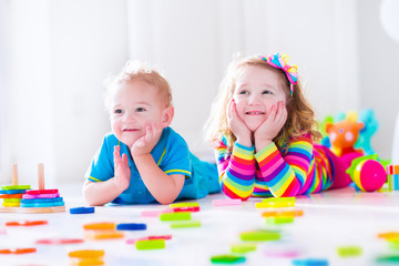 Fototapeta premium Kids playing with wooden blocks